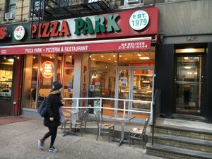 Front of pizza parlor, with some outside seating. at Pizza Park in New York City