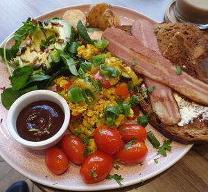 Indian spiced tofu, bacon, toast, tomatoes, half avocado, seeds and rocket. Bloody lovely! at Francesca's in Scarborough