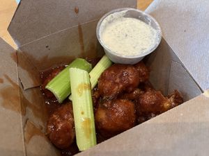 Cauliflower wings appetizer with barbecue sauce instead of buffalo. Side of ranch included.  at Envegan in East Point