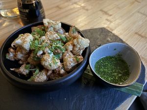Crispy fried cauliflower with kimchi sesame seeds and Nuoc Cham dip sauce  at Munchie in Chamonix-mont-blanc