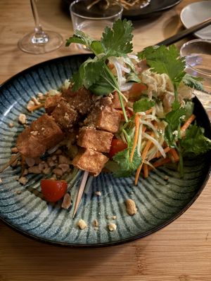 Tofu ”satay”, Som Tam salad,  thai basil, coriander, citrus salad, and crispy onion

  at Munchie in Chamonix-mont-blanc
