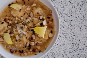 Fig and cheese goat Ravioli with honey butter sauce 
and laminated almonds at O Finalmente in Manta Rota