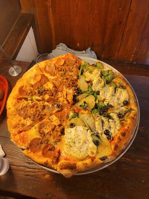 Half meat-lovers, half sunny day (yes those are potatoes 😍) at Pi Vegan Pizzeria in Seattle