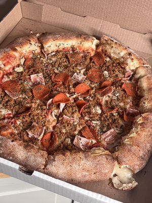 Vegan meat lovers with sun dried tomatoes, mushrooms, with a stuffed crust.   at Pi Vegan Pizzeria in Seattle