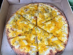 While garlic base w/mozzarella, cheddar, and pineapple   at Pi Vegan Pizzeria in Seattle