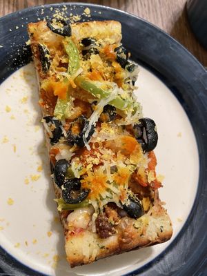 Some nooch sprinkles & homemade hot sauce makes it 🤌🤌🤌  at Pi Vegan Pizzeria in Seattle