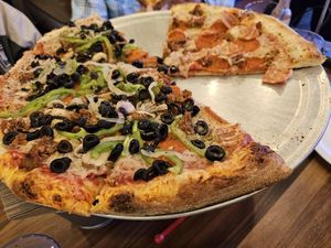 Half Supreme Vegan and half animal lovers (dug into already) at Pi Vegan Pizzeria in Seattle