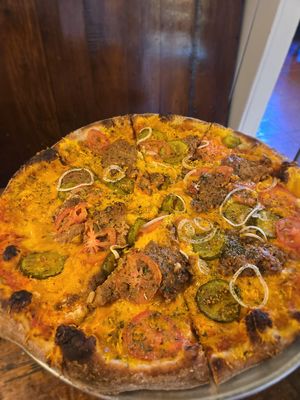 Sweet pickle cheeseburger pizza at Pi Vegan Pizzeria in Seattle