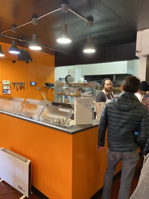 The kitchen prep and ordering counter is bright and shiny at Pi Vegan Pizzeria in Seattle