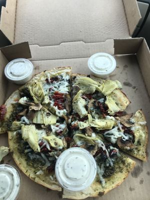 Gluten free pizza with pesto, mozzarella, artichoke, mushrooms, & sun dried tomatoes  at Pi Vegan Pizzeria in Seattle