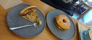Quiche with mushrooms and bagel with vegan goat cheese, pesto and baked tomatoes. at Share Sweet and Espresso Bar in Prague