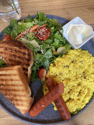 Scrambled tofu, sausages, salad, bread&butter  at Share Sweet and Espresso Bar in Prague