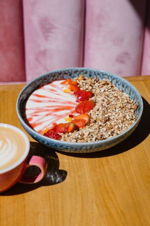 Vanilla granola with fresh strawberries and poached strawberry mash   at Share Sweet and Espresso Bar in Prague