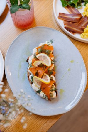 Marinated carrot salmon with fresh vegan cheese on sourdough bread at Share Sweet and Espresso Bar in Prague