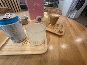 Coconut water & a flat white at Share Sweet and Espresso Bar in Prague
