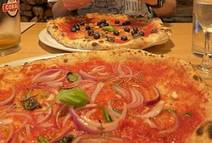 Two modified marinara pizzas - one with red onion and one with olives   at Pizzeria Lume in Funchal