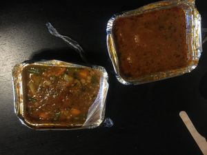 Black beans stew and cooked veggies at Rosticceria Garhwal in Padua