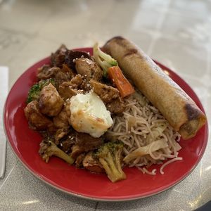A vegan stir fry  on noodles, with an added spring roll.  at HeartFood in Hobart