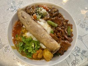 Spiced peanut, mushroom soy nuggets, and lentil curry on rice. Topped with a spring roll. 😝  at HeartFood in Hobart