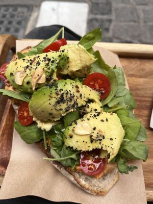 Toastado with avocado, hummus, tomatoes, seeds and fried slices of garlic  at Sur Coffee Corner in Granada