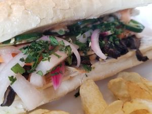 Portobello Banh Mi - sesame soy marinated portobello mushrooms on a baguette with fresh jalapenos and pickled slaw (red onions, daikon, carrots), topped with cilantro and Sriracha  at The LaFayette Place in Milwaukee