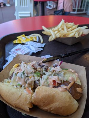 Plant-based Loaded Slaw Dog
Plant-based "Sausage" topped with Pickled Slaw, Barbecue Vegan Aïoli, and Roasted Corn Relish served with French Fries at Walt Disney World - Casey's Corner in Lake Buena Vista