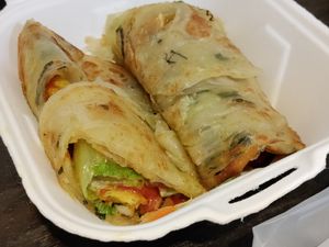 Scallion bread filled with lettuce, tomato, mayo, tofu skin? and more at Vegan Resort 啼岸 in Taipei