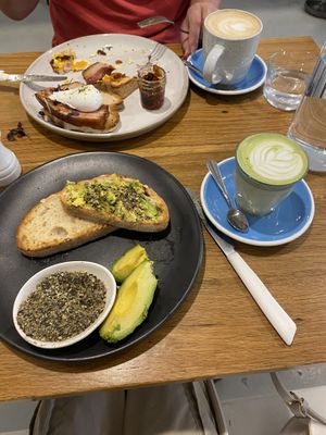 Foreground - gf sour dough toast with sides of dukkah and avocado and a vegan matcha latte 🌱 🥯🍵  at Lorna Cafe in Ferntree Gully