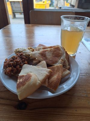 Griekse pita met paprika-tapenade en hummus at De VerbroederIJ in Amsterdam