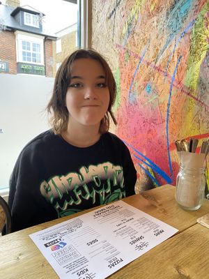 Happy young lady at VK Plant Based Diner in Waterlooville