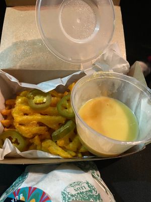 Loaded waffle fries with hot melted cheesy sauce at Leon in Cobham