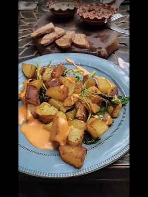 Vegan golden potatoes and vegan appetisers with homemade bread .  at DaOrganic restaurant in Sofia