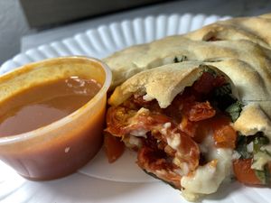 Vegan calzone with bee hive cheese and veggies  at Manicomio Pizza & Food in Asheville