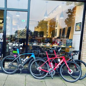 Some vegan cyclists in for vegan chocolate milkshake, vegan pizza and vegan cheesecake  at The Hub and Spoke Cafe in Dunstable