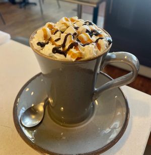 Vegan hot chocolate with non dairy cream at The Hub and Spoke Cafe in Dunstable