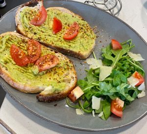 Avocado and tomato on award winning sourdough. Vegan cheese on garnish at The Hub and Spoke Cafe in Dunstable