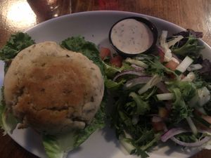 Bean burger on a gluten free bun with side salad and vegan ranch at Lucky's Taproom and Eatery in Dayton