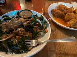 Buffalo Cauliflower bites, Grilled Kale and Beet salad with seitan sub and no cheese  at Lucky's Taproom and Eatery in Dayton