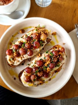 Tuscan Toast: cashew cream base, grilled grapes tossed in olive oil with lemon thyme and roasted hazelnuts at Nabo in Kingsville