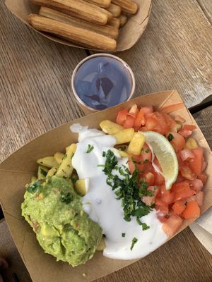 Vegan churros and garlic fries with guacamole, vegan sour cream and tomatoes  at Frittenwerk - Friedrichstraße in Berlin