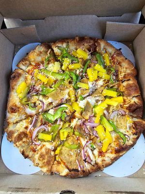 Thai Chicken - Kikkoman Thai chile sauce, vegan garlic mozzarella, vegan chicken, pineapple, red onion, green peppers, sesame seeds at Pizza Uncommon in West Lafayette