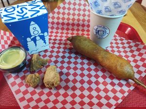 Left: Meteoritos (like popcorn chicken) Right: Deep-fried sausage on stick covered in batter at Stankov - Chapinero in Bogota
