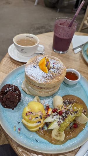 Pancakes, ice cream, fruits, pear puree, maple syrup at Good One Café in Hamburg