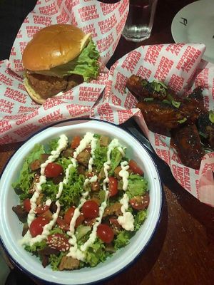 Caesar Salad, Korean fried chicken, and burger at Really Happy Chicken at Vaulty Towers in South East London