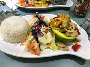 Stuffed avocado with vegan chicken and peppers, salad, rice, and black beans at Eileens Kitchen  in San Juan