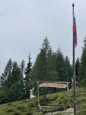 Welcome sign and Slovenian flag.  at Krekova koča na Ratitovcu in Torka