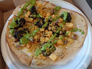 WHITE AND GREEN FLATBREAD. Pesto, spinach, broccoli, ricotta, mozzarella, pistachios, lemon, olive oil. Subbed tofu for the chicken, plant-mozz and plant-ricotta to make it vegan. at Evexia in Aurora