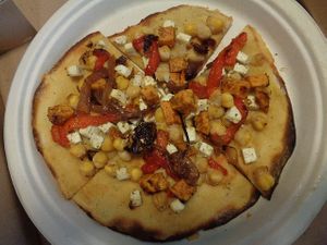 Hummus Flatbread. Hummus, chickpeas, feta, red peppers, za’atar sweet potato, onion, dates, lemon, olive oil. Subbed chickpeas for chicken and tofu plant feta to make it vegan. at Evexia in Aurora