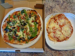 Size comparison of regular flatbread vs kids flatbread. Vegan. at Evexia in Aurora