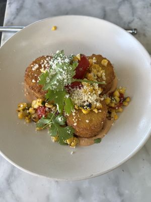 Leo’s Cakes: hash cakes with guacamole, tomatoes, and ancho crema  at Beach'n SF in San Francisco